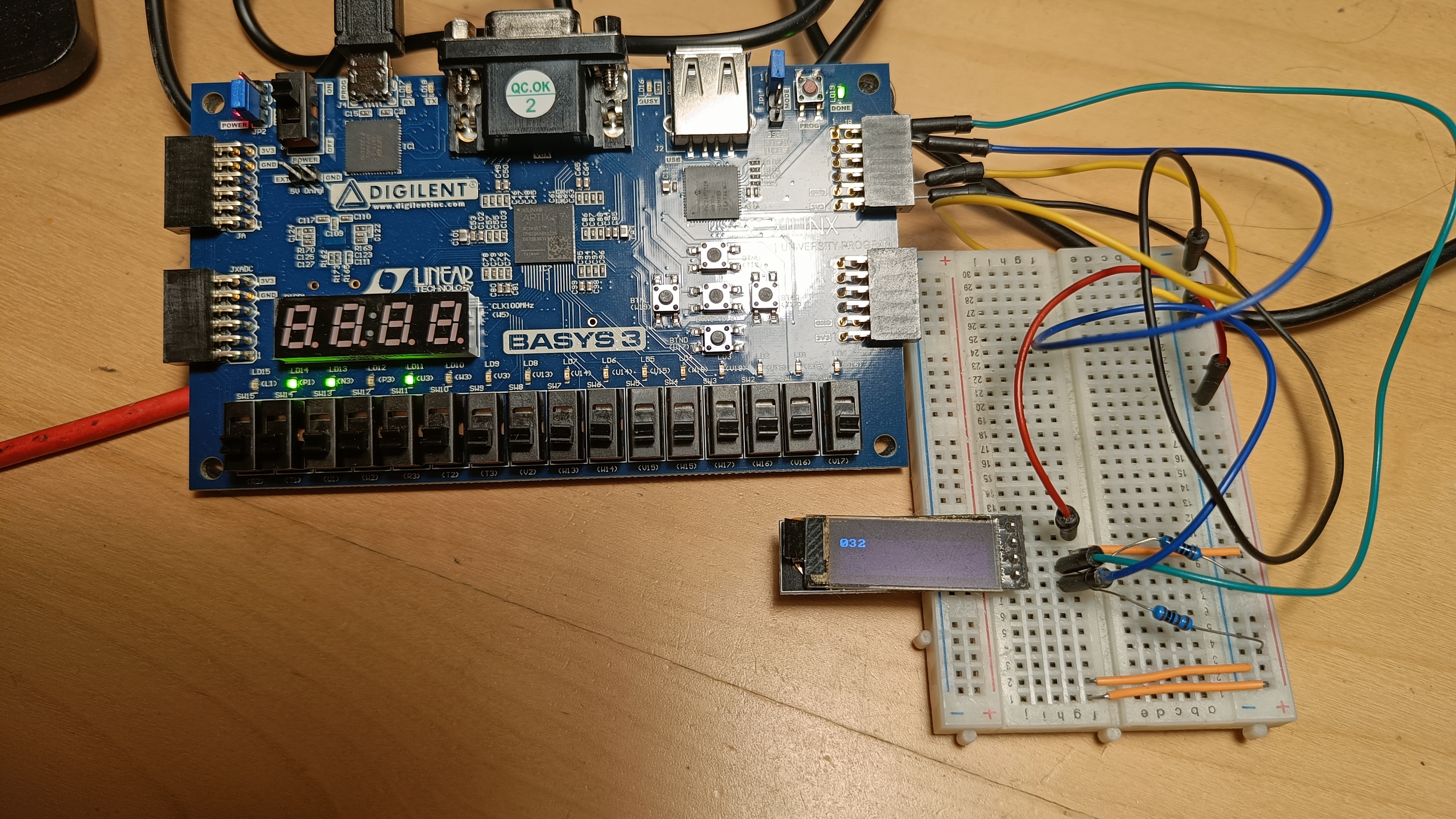Basys 3 board connected to SSD1306 display with a counter running